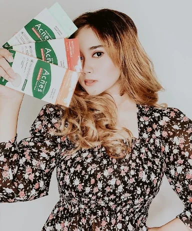 A KOC holding three Mentholatum Acnes patch packs beside her face.